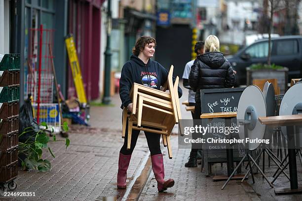 Residents and business owners begin the clean up after yesterday's floods on November 16, 2025 in Monmouth, Wales. Heavy rain caused severe and...