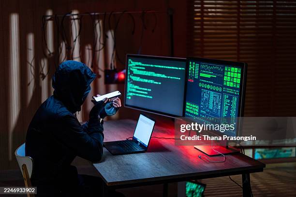 anonymous computer programmers coding or hacking into secure network database - hacking computer stock pictures, royalty-free photos & images