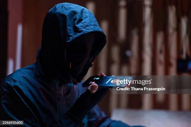 hacker in dark room coding on multiple screens - criminal stock pictures, royalty-free photos & images