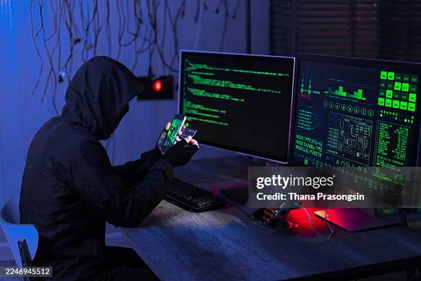 hacker coding spyware in the dark. - malicious code stock pictures, royalty-free photos & images