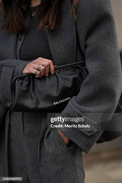 Sandra Ebert is seen wearing a dark grey Jamyna double-breasted wool jacket in blazer style with boxy silhouette and pointed lapel collar from black...