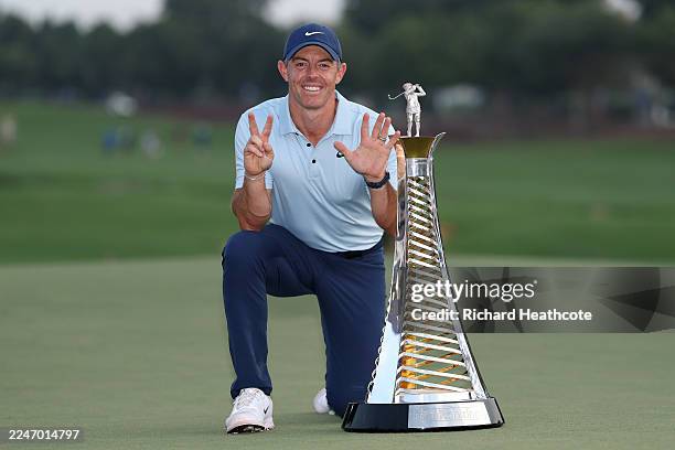 Rory McIlroy of Northern Ireland poses with the Race to Dubai trophy on the 18th green on day four of the DP World Tour Championship 2025 at Jumeirah...