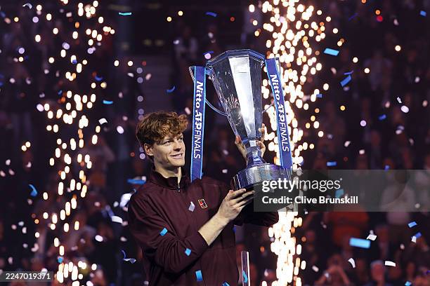 Winner Jannik Sinner of Italy lifts his trophy following the Men's Singles Final against Carlos Alcaraz of Spain on day eight of the Nitto ATP Finals...