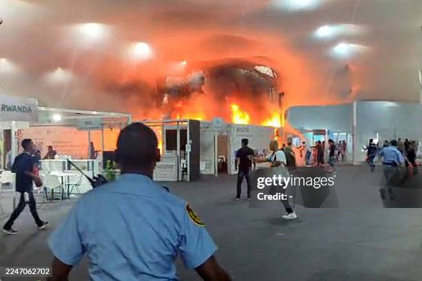This screen grab taken from AFPTV video footage shows emergency crews battling a fire that broke out at a pavilion inside the venue of the COP30 UN...