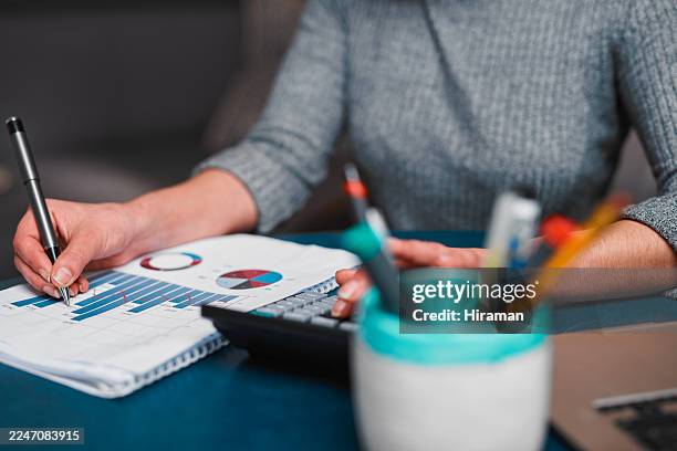 focused office work with charts, paperwork, and calculator on desk - gantt chart stock pictures, royalty-free photos & images