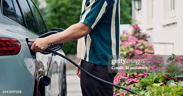 electric car, man and sustainability with green energy, hand and charge with ecology. vehicle, automobile and driver with socket, environment and nozzle with climate change, eco friendly and supply - electric car stock pictures, royalty-free photos & images