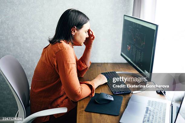 focused woman programmer working at modern desk with computer and coding on screen - old computer stock pictures, royalty-free photos & images