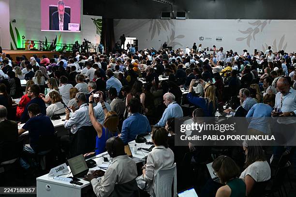 Attendees listen to COP30 President Andre Correa do Lago during a plenary session of the COP30 UN Climate Change Conference in Belem, Para state,...