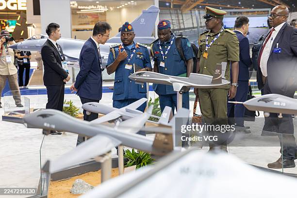 People visit the booth of China National Aero-Technology Import & Export Corporation at the Dubai Airshow 2025 on November 17, 2025 in Dubai, United...