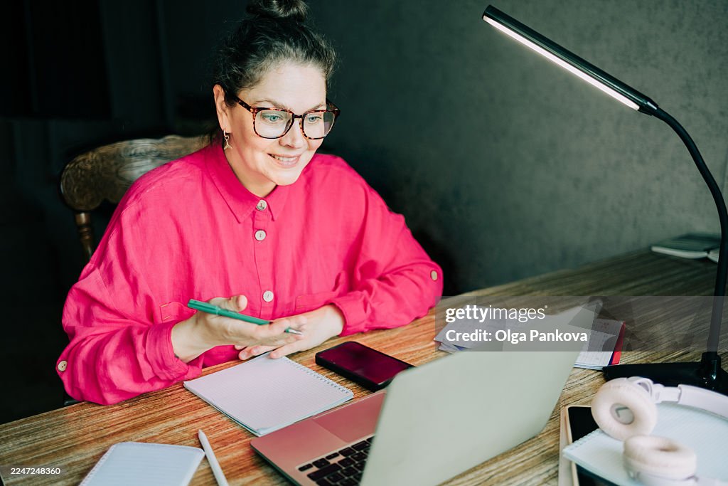 Woman working from home during video call with laptop