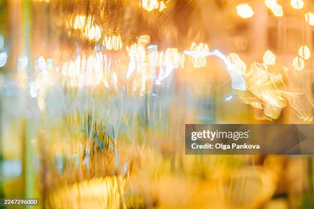 city lights bokeh reflection on wet glass at night - flouté photos et images de collection