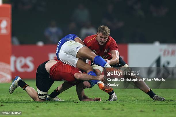 Rodney Iona of Samoa is tackled by Toon Deceuninck and Felipe Geraghty of Belgium during the Men's Rugby World Cup 2027 Final Qualification...