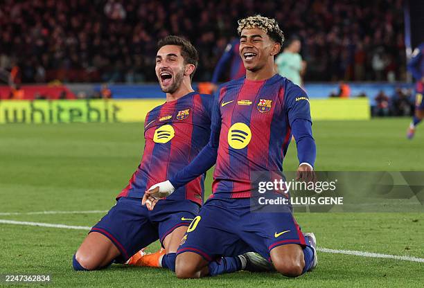 Barcelona's Spanish forward Ferran Torres celebrates with Spain's forward Lamine Yamal scoring his team's fourth goal during the Spanish league...