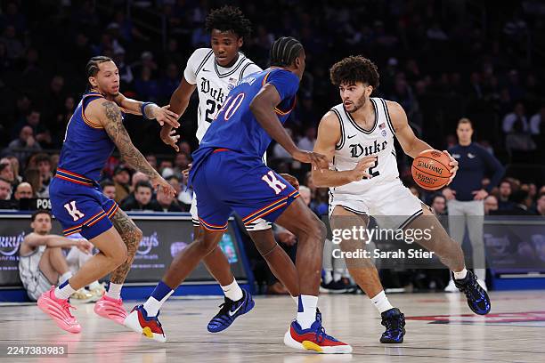 Cameron Boozer of the Duke Blue Devils dribbles against Flory Bidunga of the Kansas Jayhawks during the first half in the 2025 State Farm Champions...