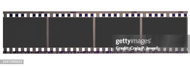 4 panel strip of retro 35mm film isolated on a white background - fotorolletje stockfoto's en -beelden