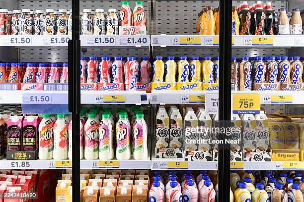 Range of flavoured milkshakes are displayed in the chilled goods aisle of a branch of the Tesco chain of supermarkets on November 19, 2025 in London,...