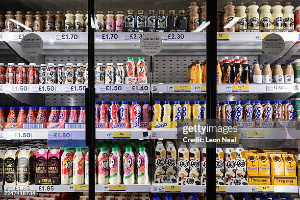 Range of flavoured milkshakes are displayed in the chilled goods aisle of a branch of the Tesco chain of supermarkets on November 19, 2025 in London,...