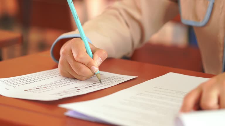 https://media.gettyimages.com/id/2247452880/video/closeup-of-hands-female-of-students-taking-exams-in-a-classroom-exams-in-school-writing-and.jpg?b=1&s=640x640&k=20&c=cMxCvc46Dn8lscNbVyHwLc_M_6WKAfrANpWrCnsct3Q=
