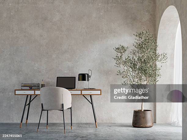 a minimalist simple home office interior with a desk, a chair, a potted plant placed against a weathered wall, on concrete floor, arched doorway or window with curtains - shabby chic stock pictures, royalty-free photos & images