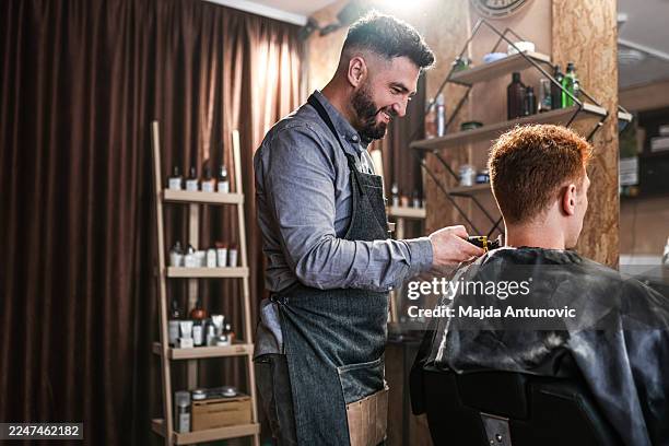 barber detailing haircut with clipper - barber stock pictures, royalty-free photos & images