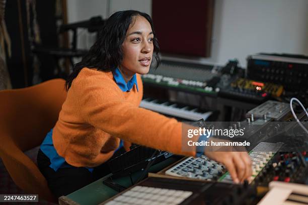 woman creating electronic music in recording studio - electronic music stock pictures, royalty-free photos & images