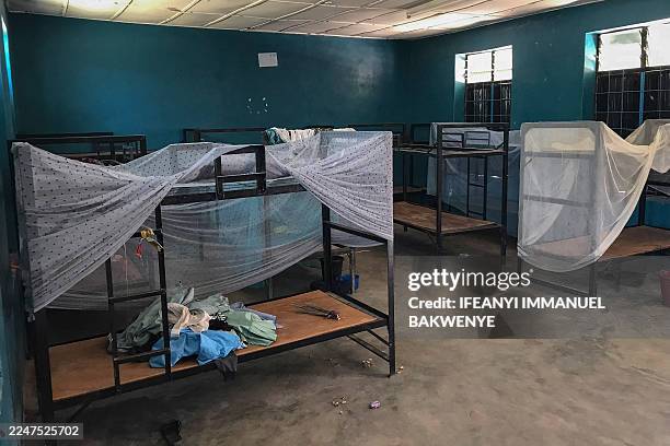 General view of empty bunk beds and scattered belongings inside a student dormitory at St. Mary's Catholic School in Papiri, Agwarra local...