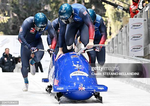 Great Britain's team pushes their bobsleigh at the start in the 4-men Bobsleigh race at the IBSF Bobsleigh and Skeleton World Cup during Milano...