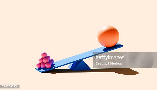 tiny pink spheres outweigh giant orange ball - underdog triumph - gungbräda bildbanksfoton och bilder