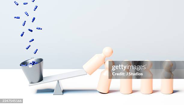 tiny blue pegs toppling giant beige pegs - ripple of influence - domino effect stock pictures, royalty-free photos & images