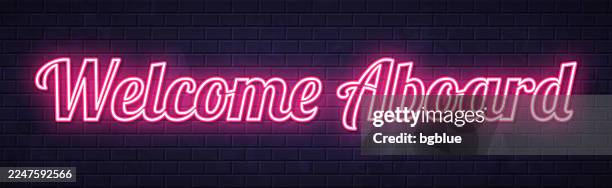 welcome aboard - glowing neon text on brick wall background - welcome aboard stock illustrations