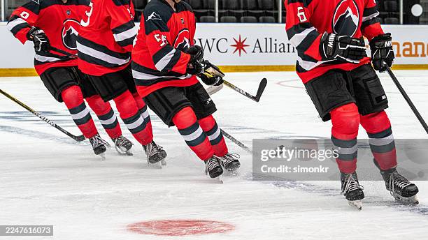 hockey players energetically sliding during pre game warm up - uniforme de hóquei no gelo imagens e fotografias de stock