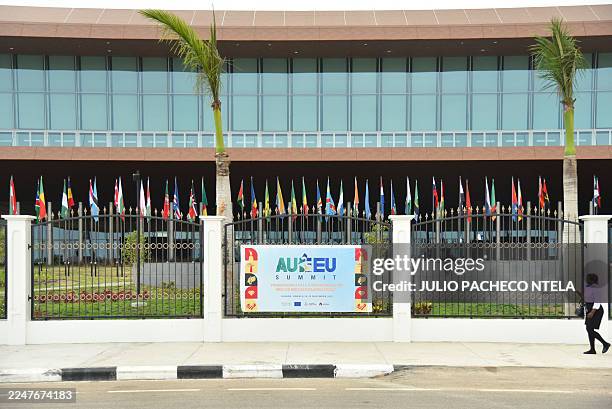 Woman approaches a banner placed on the gating of the Salao Protocolar in Luanda on November 24 where the Africa Union - European Union summit takes...