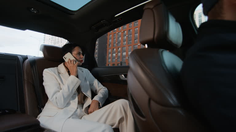 https://media.gettyimages.com/id/2247700562/video/mature-woman-talking-on-phone-while-commuting-to-work-by-business-class-car.jpg?b=1&s=640x640&k=20&c=bl4ssW9UGHeAWoEoCMvrRCjZ7HnY2xflhDfuVFau3Jc=