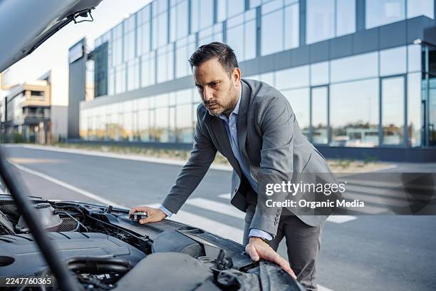 stressed businessman dealing with broken down car - one stop service stock pictures, royalty-free photos & images