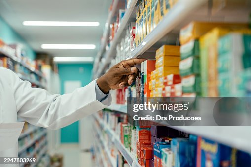 Pharmacist checking medications on the pharmacy shelf. Pharmacist checking medications on the pharmacy shelf.