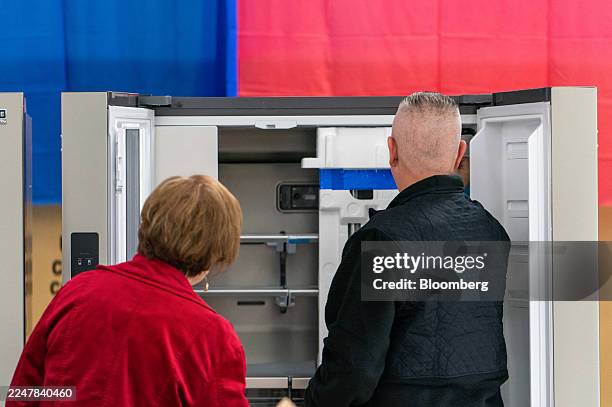Worker shows a refrigerator to a customer at an appliance store in Midwest City, Oklahoma, US, on Monday, Nov. 24, 2025. The US Census Bureau is...