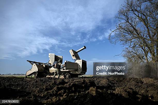 Demining operator of the 808th Dniester Separate Support Brigade of the Armed Forces of Ukraine works beside a GCS-200 mechanical demining machine...