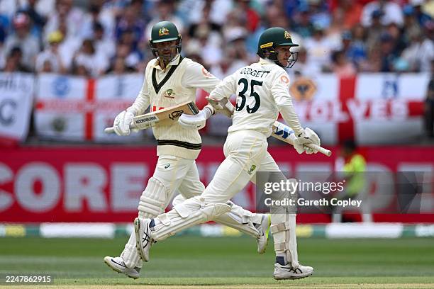 Brendan Doggett and Nathan Lyon of Australia run between the wickets during day two of the First 2025/26 Ashes Series Test Match between Australia...