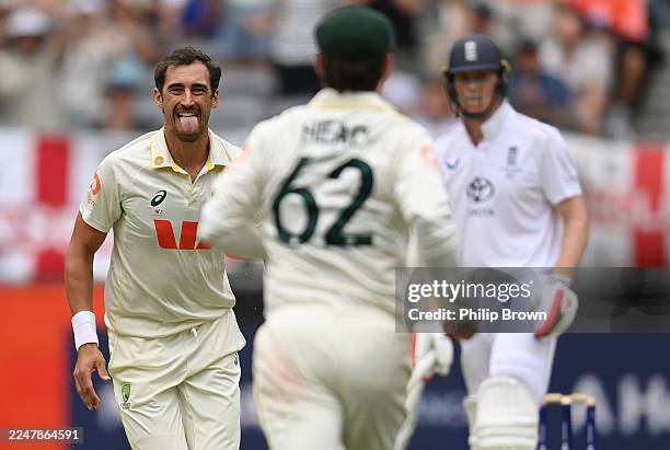 Mitchell Starc of Australia reacts after catching Zak Crawley during day two of the First 2025/26 Ashes Series Test Match between Australia and...