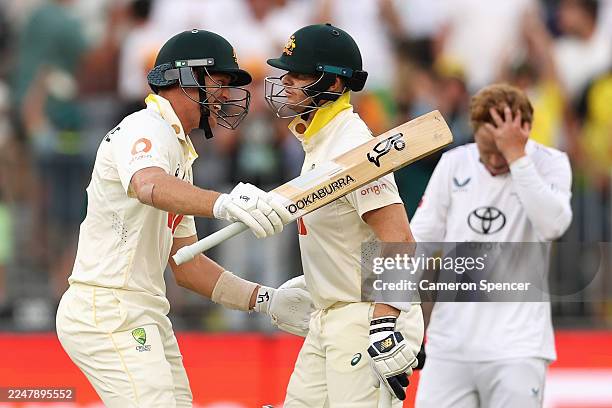 Marnus Labuschagne of Australia celebrates winning the first test with team mate Steve Smith of Australia during day two of the First 2025/26 Ashes...