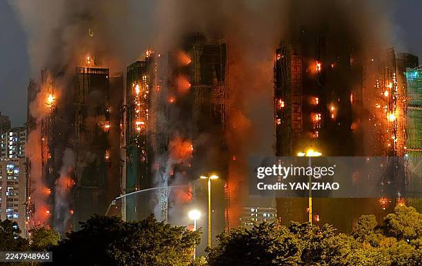 Thick smoke and flames rise as a major fire engulfs several apartment blocks at the Wang Fuk Court residential estate in Hong Kong's Tai Po district...