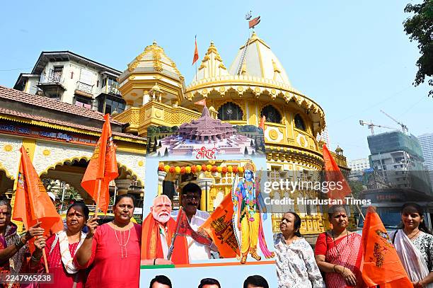 As a symbol of the flag hoisting ceremony to be held at the Ram Temple in Ayodhya by Prime Minister Modi, devotes celebrating a cut-out of the Ram...