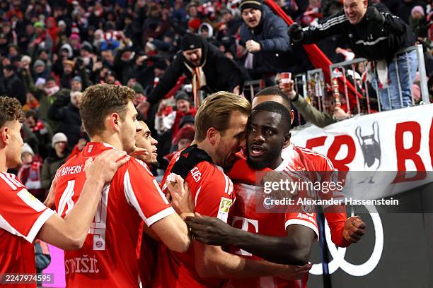 Dayot Upamecano of Bayern Munich celebrates scoring his team's third goal with teammates during the Bundesliga match between FC Bayern München and SC...