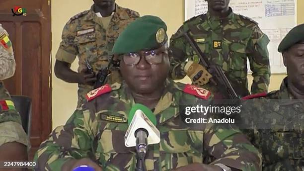 Screen grab shows the Head of the Presidential Military Office of Guinea-Bissau, Denis N'Canha , announcing with a group of officers that full...
