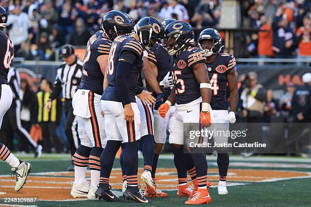 Caleb Williams celebrates with Kyle Monangai of the Chicago Bears after he scored a fourth quarter touchdown against the Pittsburgh Steelers at...