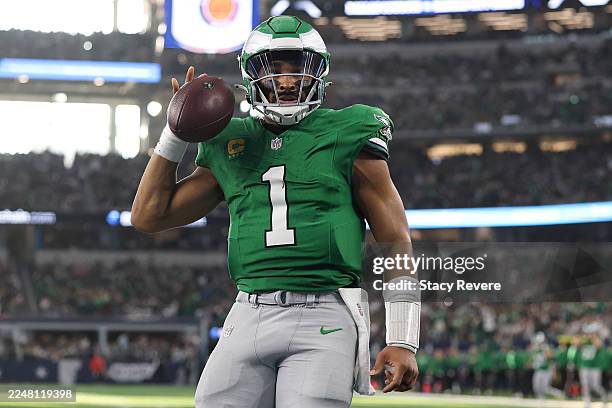 Jalen Hurts of the Philadelphia Eagles reacts to scoring a touchdown in the first quarter against the Dallas Cowboys at AT&T Stadium on November 23,...