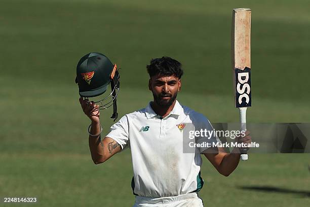 Nikhil Chaudhary of the Tigers celebrates and acknowledges the crowd after scoring a century during day three of the Sheffield Shield match between...