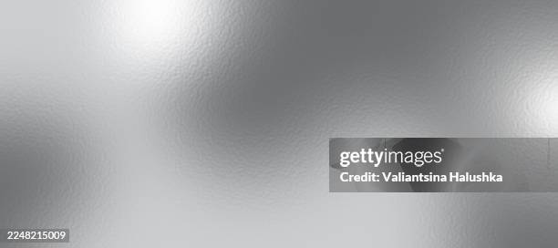 Silver foil texture background with light reflection