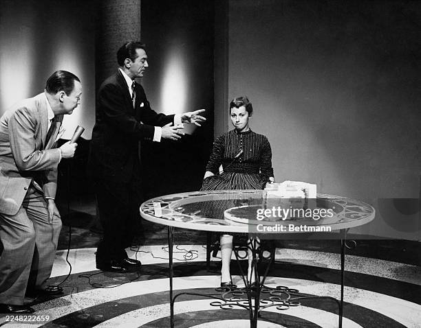 American hypnotist Arthur Ellen hypnotises college student Pat Morris during an episode of the television game show 'Truth or Consequences' as...