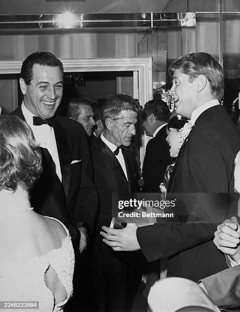 American actor Rock Hudson jokes with groom Troy Donahue at a reception following Troy's marriage to Suzanne Pleshette, Beverly Hills, California,...